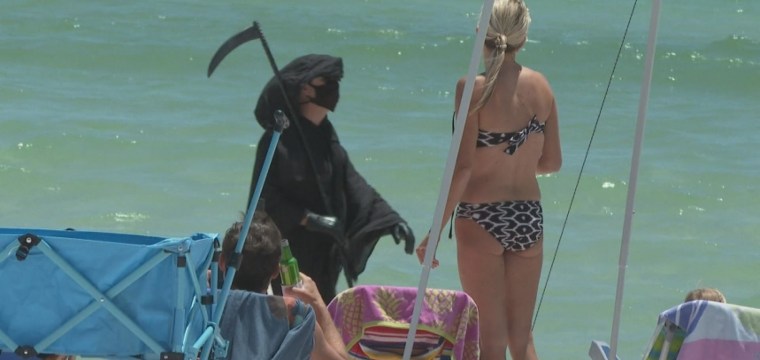Man dresses as Grim Reaper to warn Florida beachgoers about coronavirus